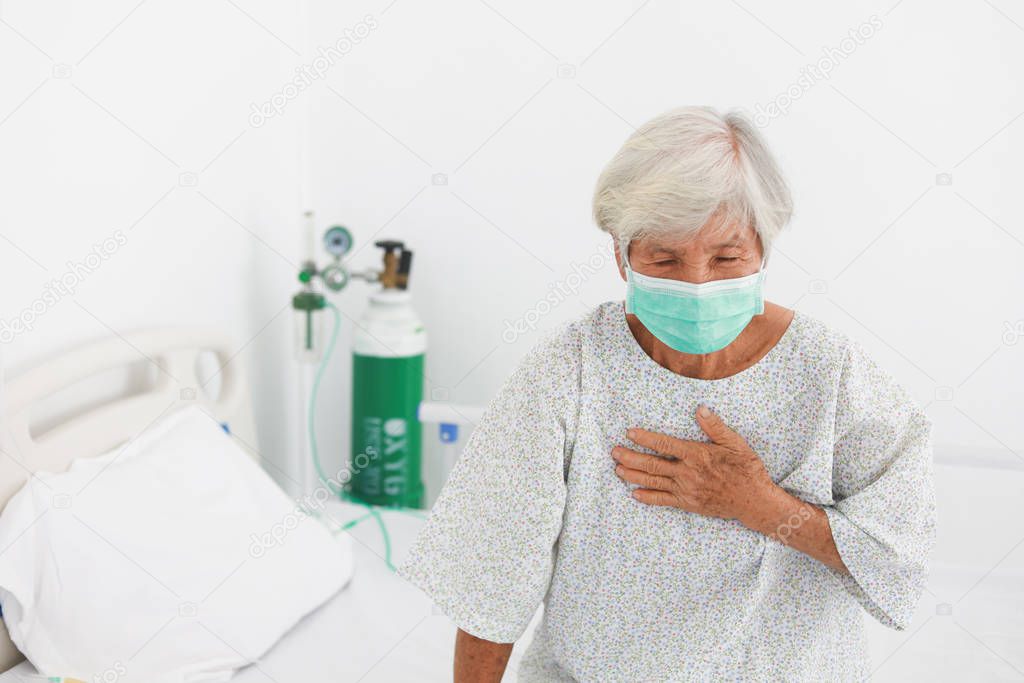 Asian old Patient woman  with mask sickness in hospital room with virus flu