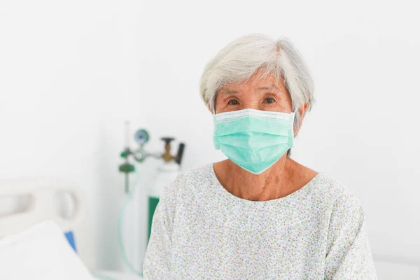 Asian doctor checking Asian old woman sick wih virus in hospital clinic