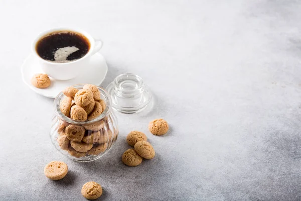 Amaretti cookies with white cup of coffee — Stock Photo, Image