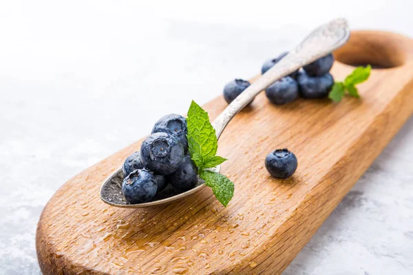 Freshly picked blueberries in vintage spoon — Stock Photo, Image