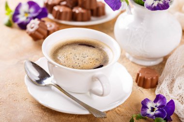 Cup of coffee with chocolate candies clipart