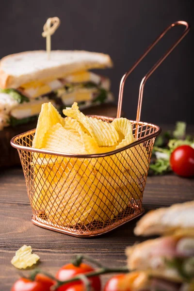 Crispy potato chips in copper basket — Stock Photo, Image