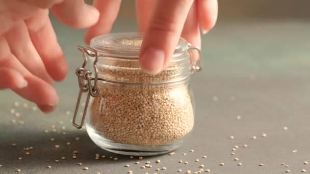 White raw quinoa in glass jar — Stock Video