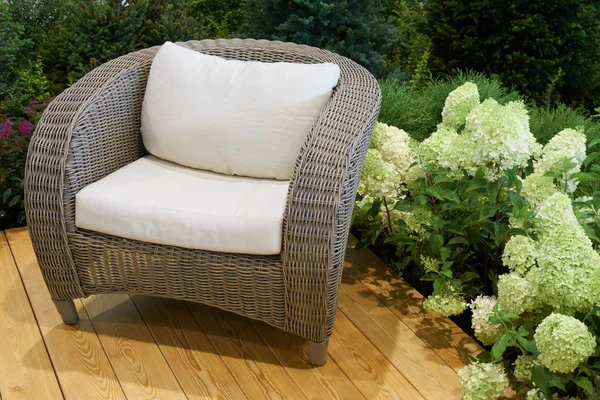 Wicker chair in the garden — Stock Photo, Image