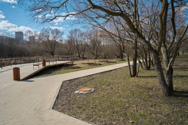 Moskova 'nın Yuzhnoye Medvedkovo semtinde bahar aylarında pedistian yürüyüş yolları ile parkın manzarası