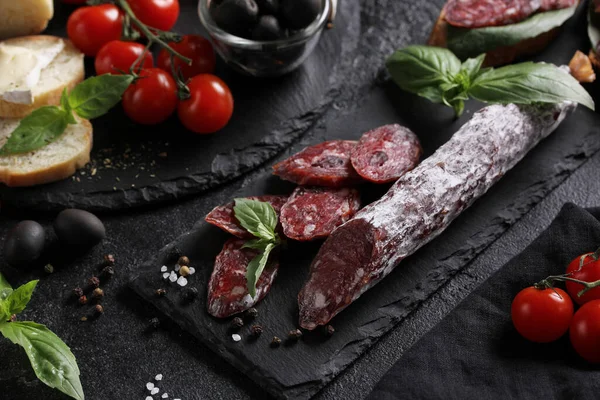Concept Italian Cuisine Sausage Black Board Tomatoes Olives Basil Cheese — Stock Photo, Image