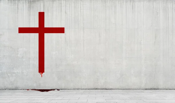 Catholic cross drawn in red paint on a concrete wall.