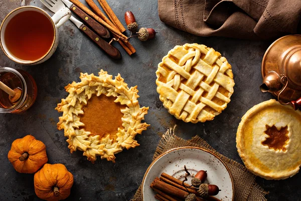 Homemade pumpkin pies decorated with fall leaves — Stock Photo, Image