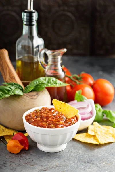 Homemade spicy tomato salsa with vegetables and olive oil — Stock Photo, Image