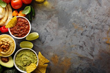 Ev yapımı Humus, salsa ve guacamole mısır cipsi ile