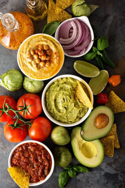Homemade hummus, salsa and guacamole with corn chips — Stock Photo, Image