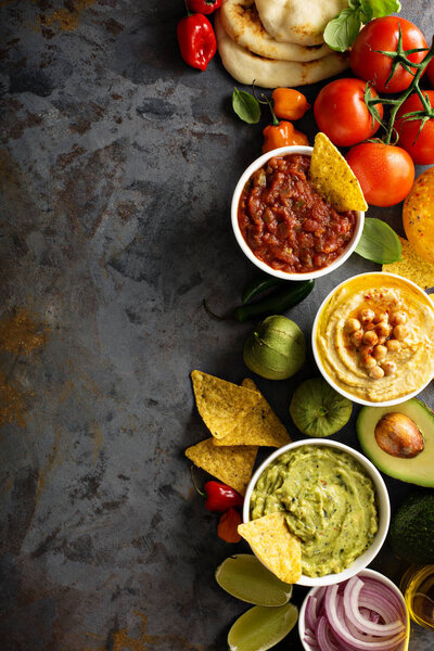 Homemade hummus, salsa and guacamole with corn chips