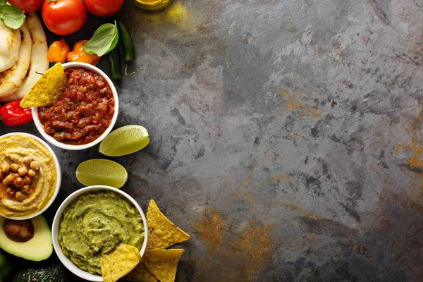 Homemade hummus, salsa and guacamole with corn chips — Stock Photo, Image