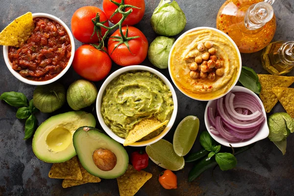 Homemade hummus, salsa and guacamole with corn chips — Stock Photo, Image