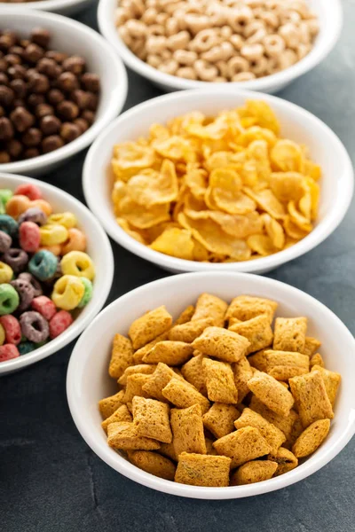 Variety of cold cereals in white bowls — Stock Photo, Image