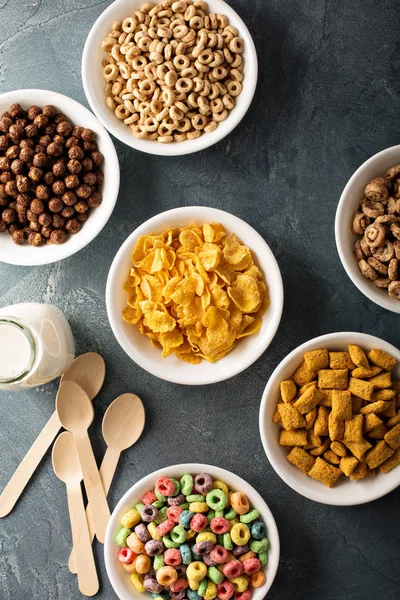 Variety of cold cereals in white bowls — Stock Photo, Image