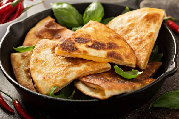 Cheese quesadillas in a cast iron pan — Stock Photo, Image