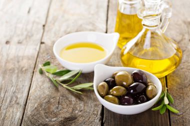 Şişe ve bir kase zeytin ile zeytinyağı
