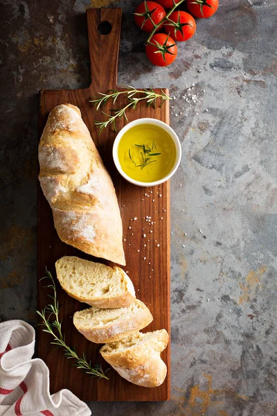 Homemade baguette with olive oil and salt — Stock Photo, Image