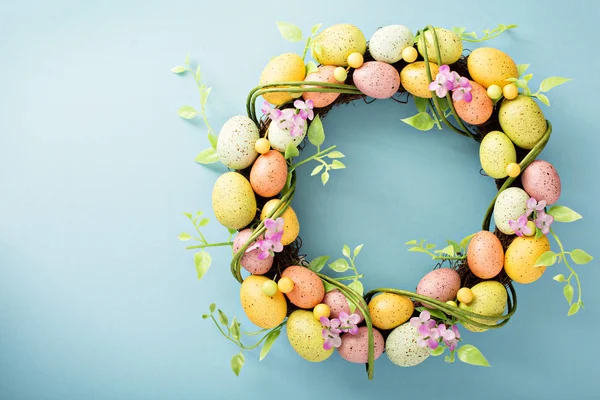 Easter eggs wreath on light blue background — Stock Photo, Image