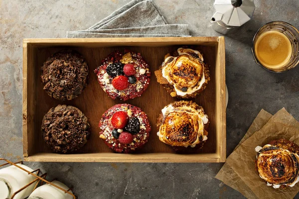 Variety of donuts in a wooden box — Stock Photo, Image
