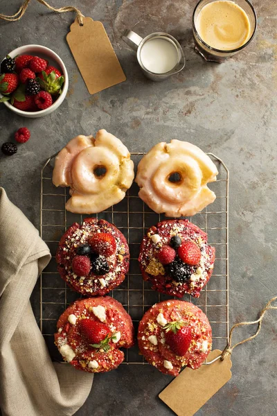 Variety of donuts on a cooling rack — Stock Photo, Image