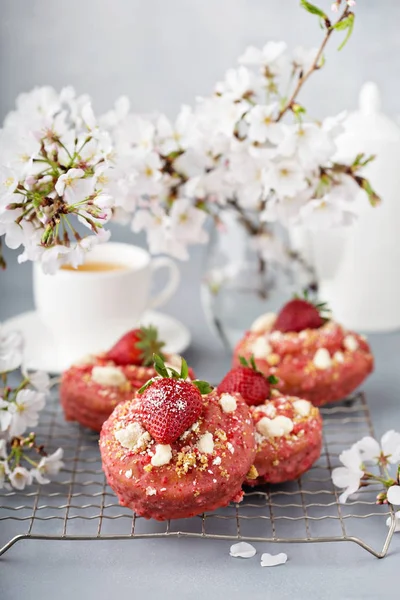 Strawberry shortcake donuts on a cooling rack
