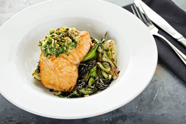 Grilled salmon on the bed of sauteed greens — Stock Photo, Image