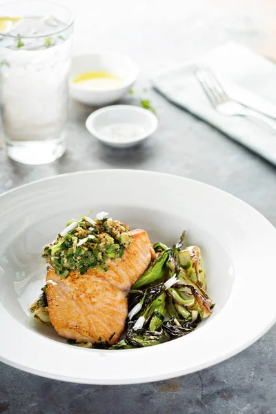 Grilled salmon on the bed of sauteed greens — Stock Photo, Image