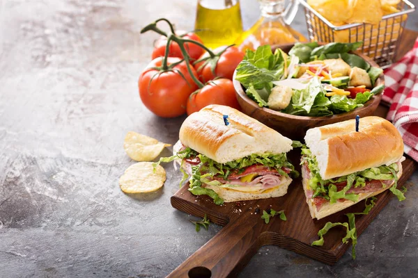 Italian sub sandwich with chips — Stock Photo, Image