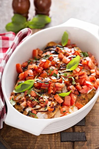 Bruschetta chicken with cheese, fresh tomatoes and basil — Stock Photo, Image