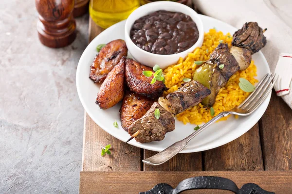 Beef kebab with rice, beans and fried plantains — Stock Photo, Image