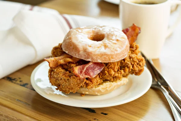 Fried chicken and bacon sandwich in a donut