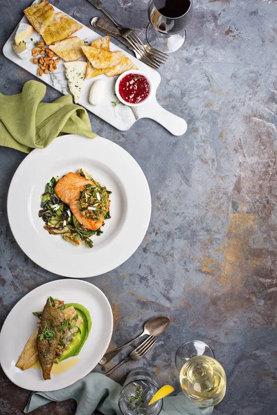 Big dinner table overhead view with steak and fish — Stock Photo, Image