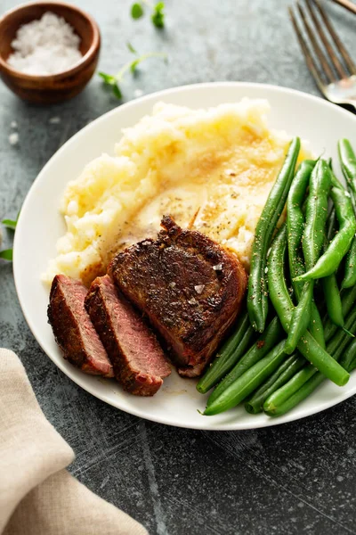 Repas traditionnel avec un steak au bacon et pommes de terre — Photo