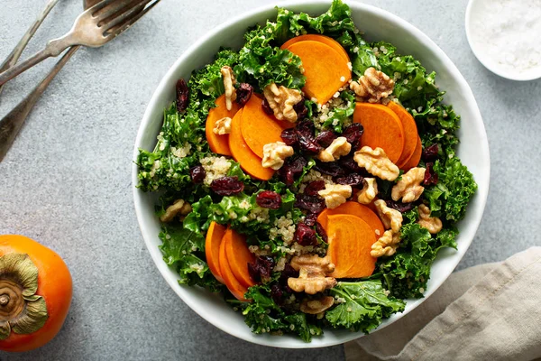 Fall or winter salad with persimmon and kale