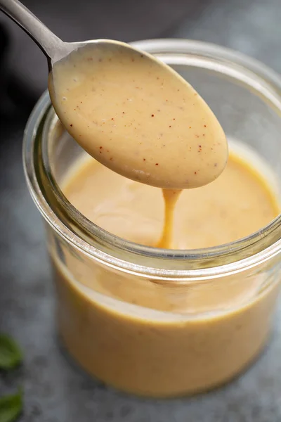 Homemade honey mustard souse in a glass jar — стоковое фото