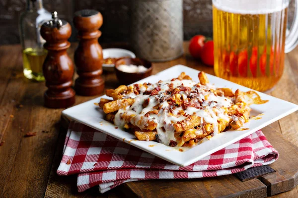 Cheese fries topped with bacon — Stock Photo, Image