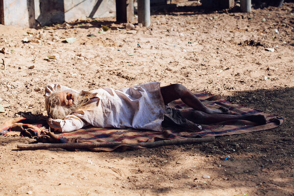 PUSHKAR, INDIA - JAN 16, 2017 Homeless man sleeping on the stree
