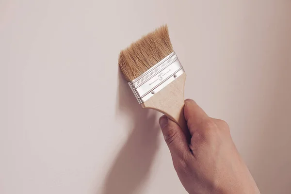 Pintor pintando la pared blanca en casa — Foto de Stock