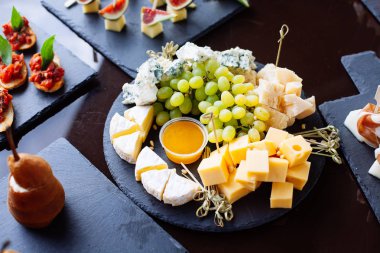 Peynir tabağı: Emmental, Camembert peyniri, mavi peynir üzüm ile