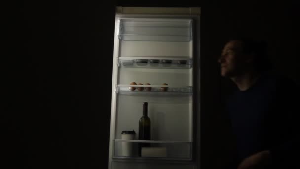 Голодний Чоловік Розладом Харчування Дивлячись Холодильник Приймаючи Їжу Вночі Концепція — стокове відео