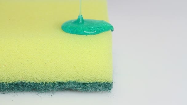 Blue Dish Washing Liquid Gel Pouring Yellow Sponge White Background — Αρχείο Βίντεο