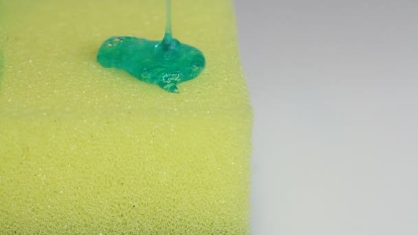 Gel Líquido Lavado Platos Azules Vierte Sobre Una Esponja Amarilla — Vídeo de stock