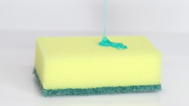 Blue Dish Washing Liquid Gel Pouring Yellow Sponge White Background — 图库视频影像