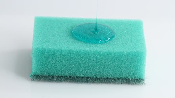 Blue Dish Washing Liquid Gel Pouring Green Sponge White Background — 图库视频影像