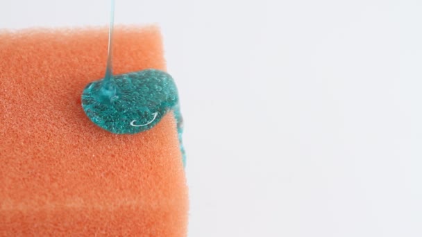Blue Dish Washing Liquid Gel Pouring Orange Sponge White Background — Stok video