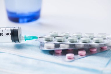 Medications pills drug, glass of water, mask and syringe. Flu ou