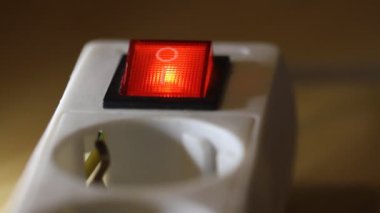 Female finger presses the red on/off power button. Close up video, selective focus