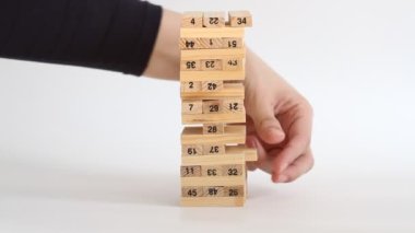 Kadın ve erkek beyaz arka planda jenga oynuyor. Aile eğlencesi ve tatil konsepti.